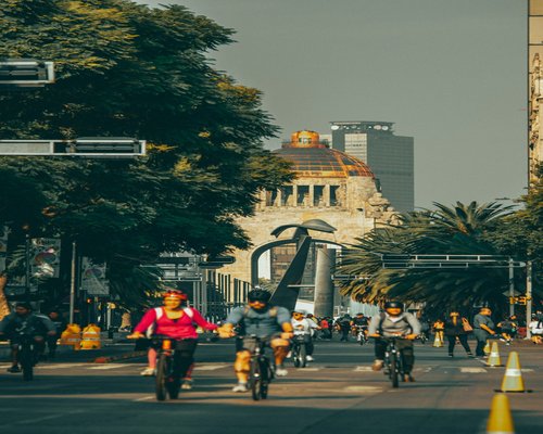 Busy street intersection in Mexico city with blurred traffic and pedestrians